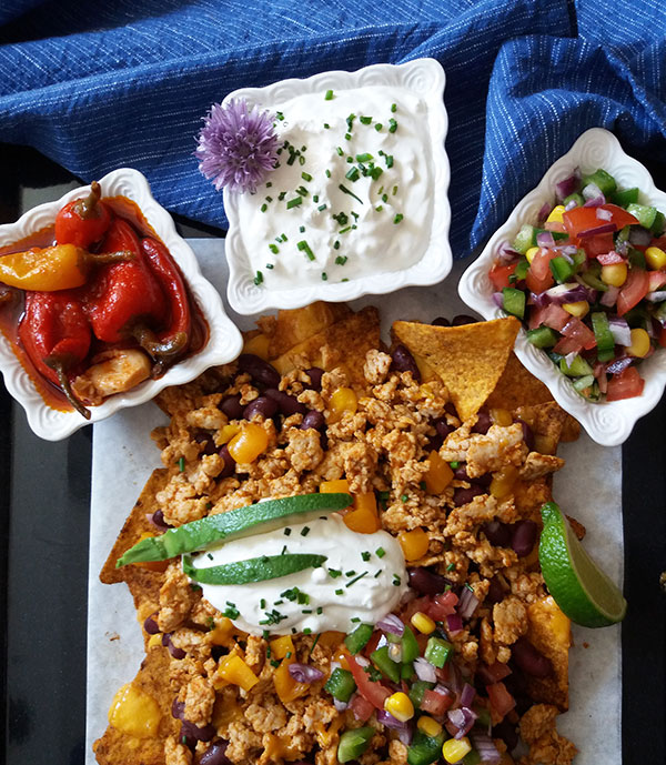 The Best Turkey Nachos: sheet pan nacho recipe, loaded with red beans, ground turkey, Cheddar cheese, garnished with pico de gallo, avocado and sour cream. Any chicken, beef or leftover turkey are great to use also!