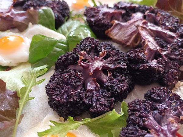 Purple Cauliflower Steaks are made of simply cut slices of purple cauliflower, brushed with olive oil, sprinkled with salt, oven roasted to make an easy week dinner served the way it suits you the best !