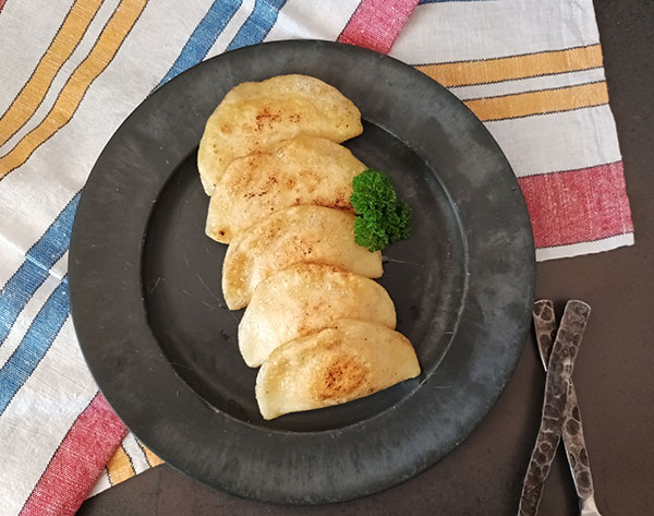Vareniki are Ukrainian perogies recipe aka pierogies. Dumplings filled with cottage cheese, boiled in salted water are budget friendly tasty lunch or dinner everybody loves!