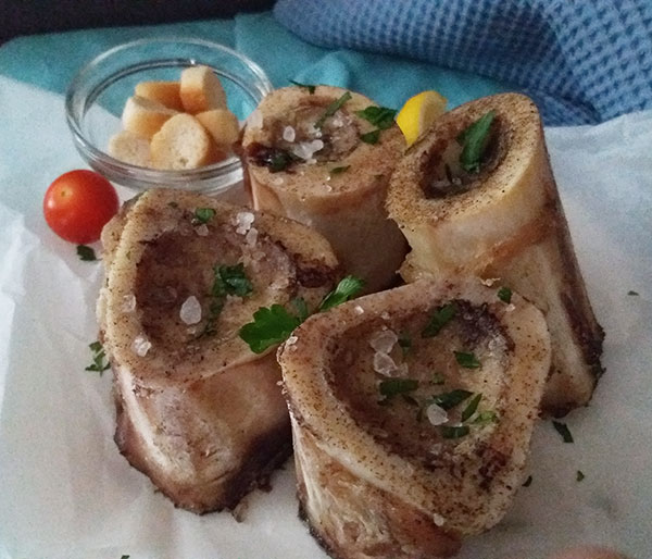 Roasted Bone Marrow Recipe using beef bones makes the base for various tasty dishes. It can be served alone as delicate appetizer. All you need is salt, ground black pepper and fresh herbs to enjoy it on a slice of toasted bread !