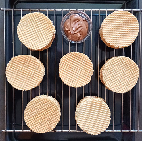 Torta Tre Monti is Sanmarinese delicacy for all Nutella, whipped cream and coffee lovers. Wafle layers cut to your favourite shape and filled to form multi layered sandwich is the best no bake dessert to enjoy without turning your oven on! 
