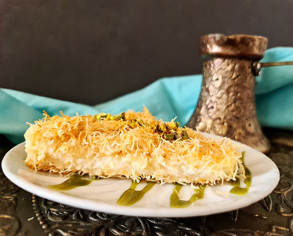 Knafeh is traditional Levant dessert made with kadayif, attar, and vanilla filling. Knafeh is traditional Levant dessert made with kadayif, attar, and vanilla filling.